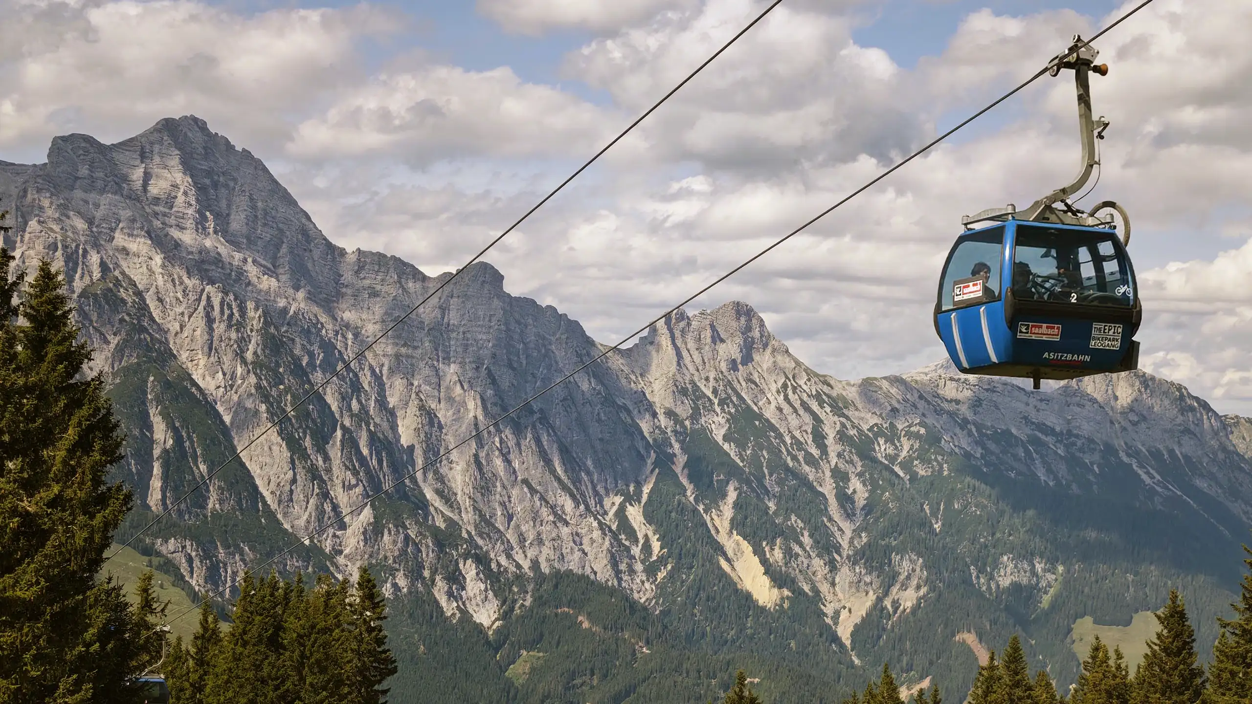Cable car gondola and ski lift above the Saalfelden-Leogang alpine landscape at sunset